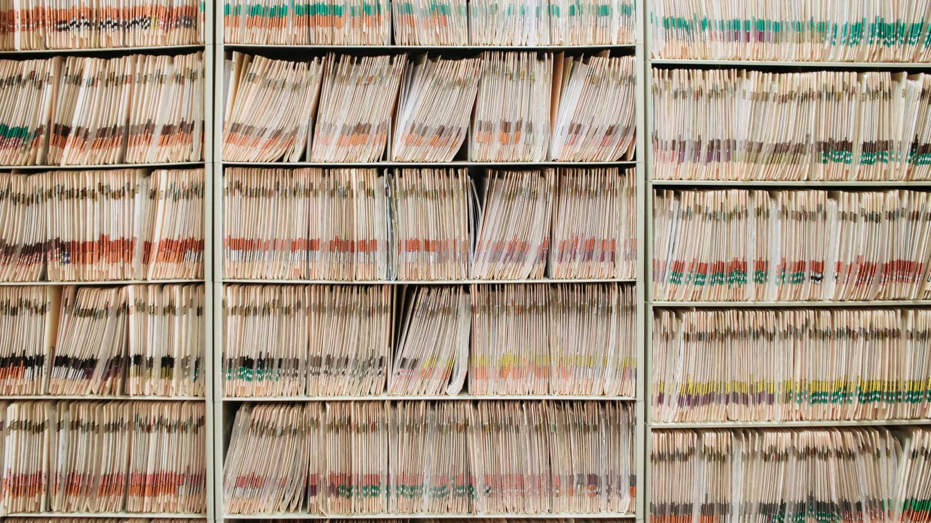 various medical record charts and folders in cabinet and on shelve sorted alphabetically and numerically