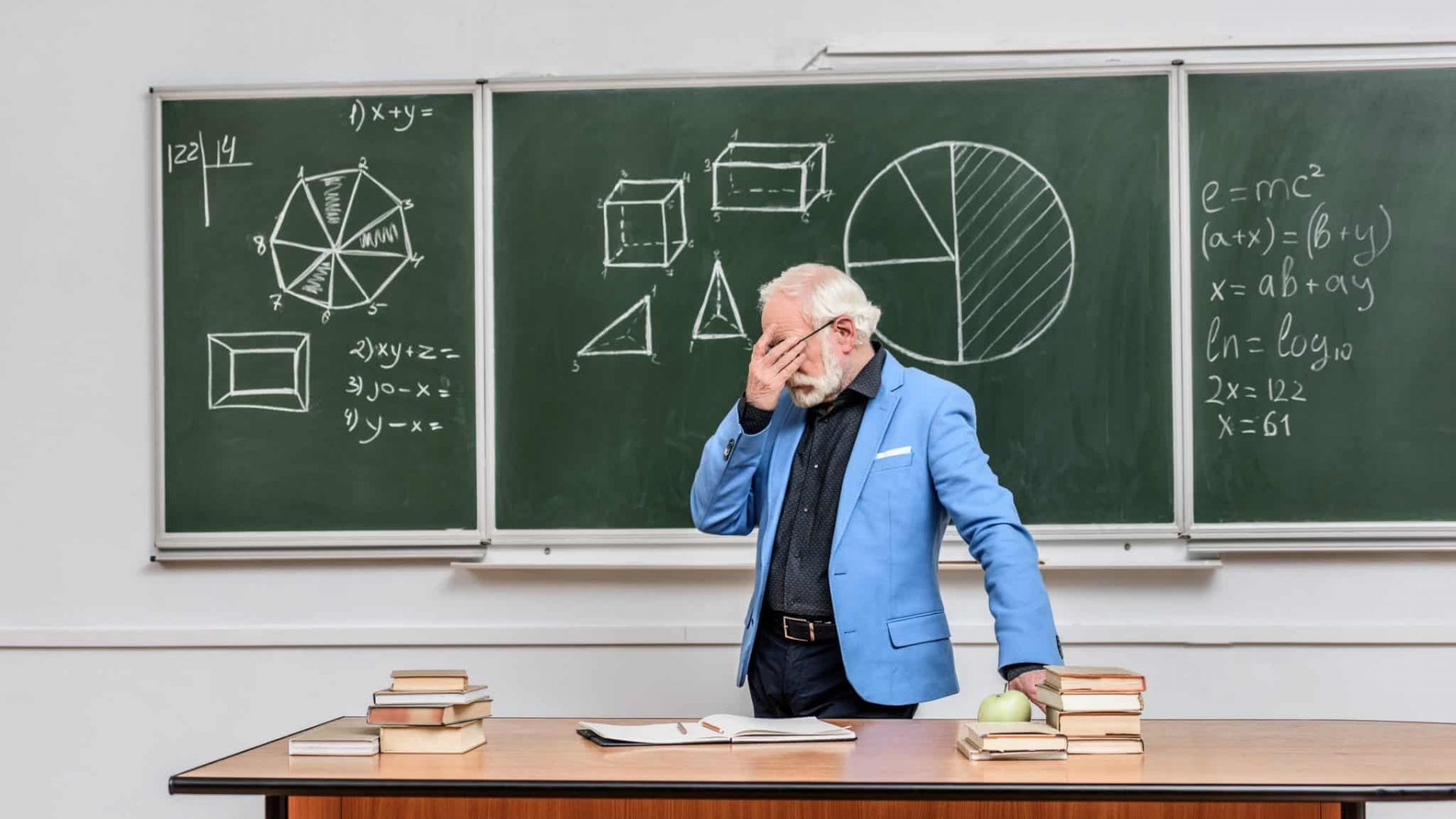 tired-grey-hair-professor-touching-eyes-at-blackbo-2022-07-08-03-10-41-utc-2048x1367