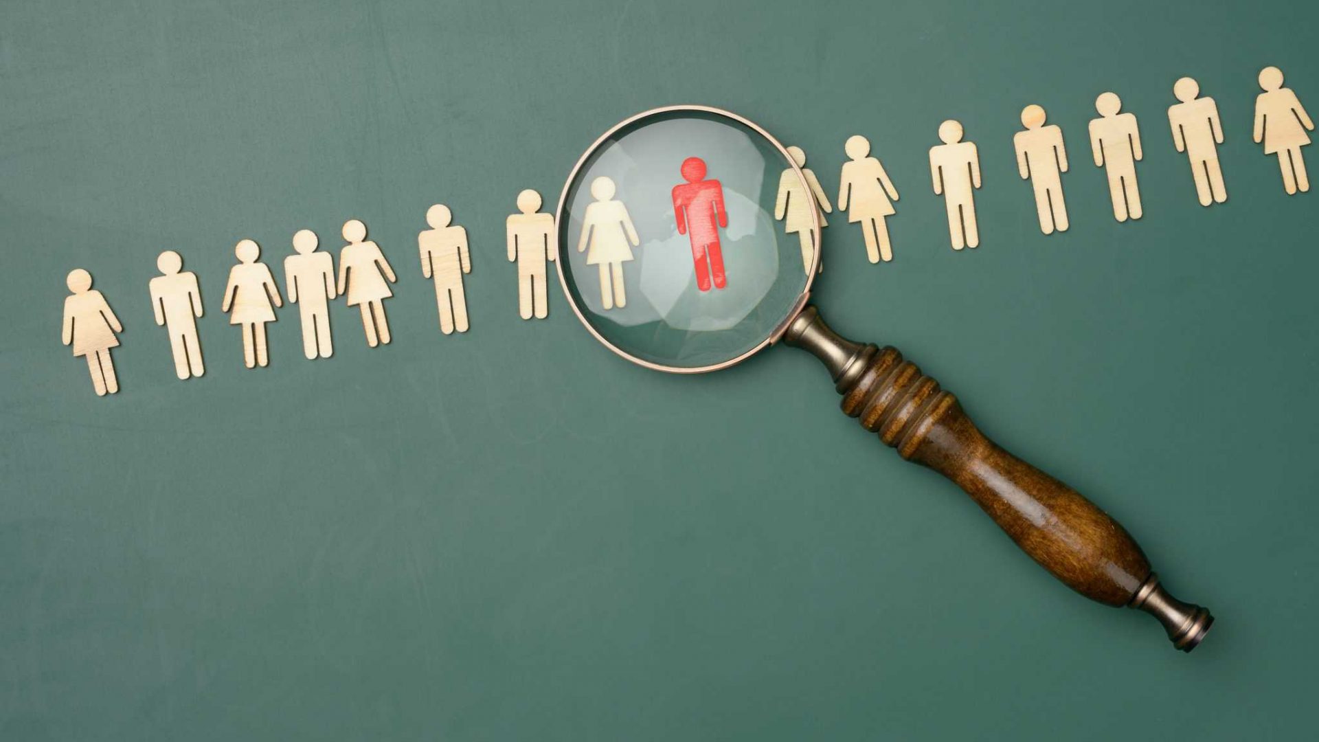 wooden-men-and-a-magnifying-glass-on-a-green-backg-2022-06-15-21-00-07-utc-2048x1438